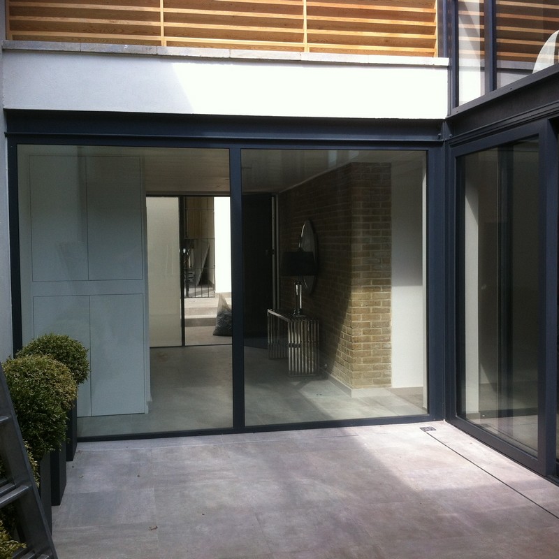 Floor-to-ceiling sliding doors opening to courtyard in St Paul's