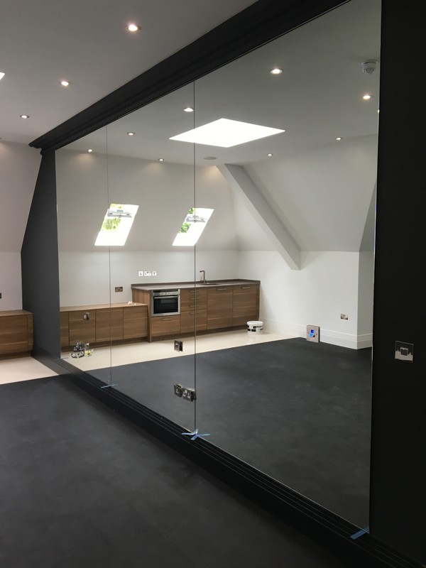 Frameless glass partition in loft conversion by St Paul's glaziers