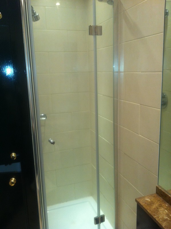 Frameless glass shower enclosure with chrome fittings in St Paul's