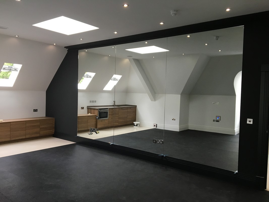 Frameless glass wall dividing loft conversion in St Paul's
