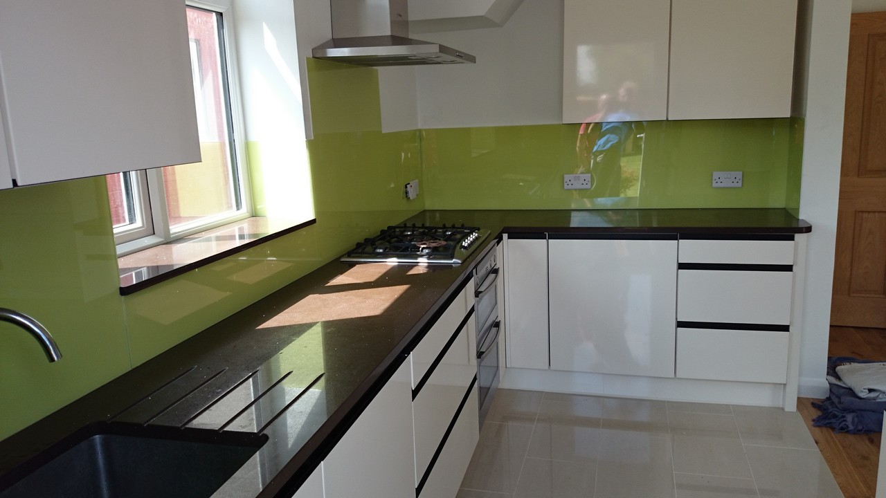Lime green glass kitchen splashback installed by St Paul's glaziers