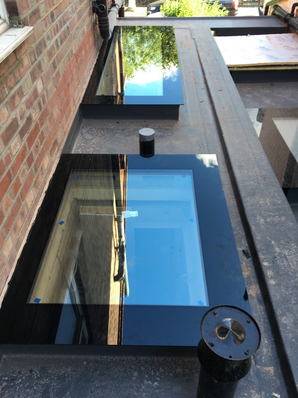 Multiple flat roof skylights on extension in St Paul's