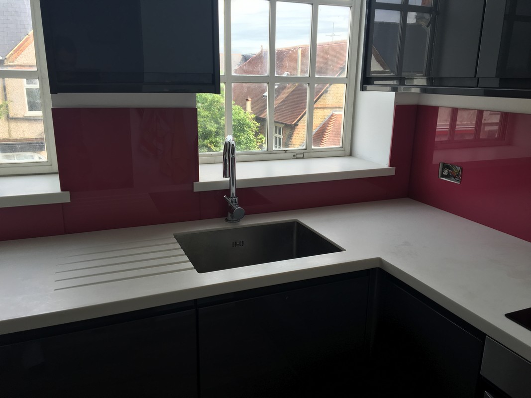 Deep plum coloured glass splashback in modern St Paul's kitchen
